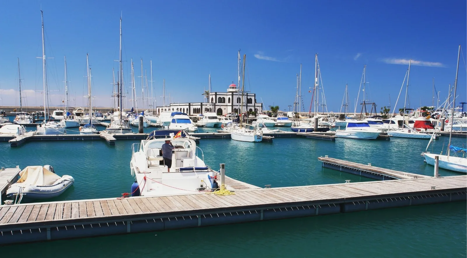 Sailing yachts and motor boats moored along floating pontoons at Marina Rubicón, Lanzarote